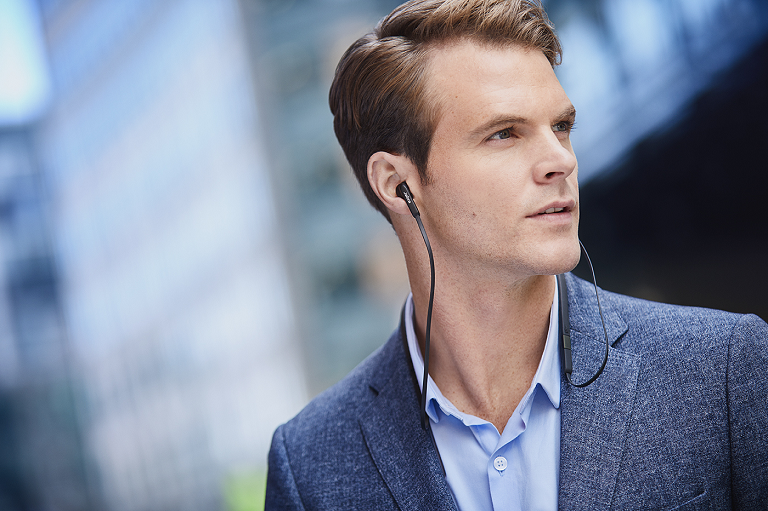 Close up of man wearing the Jabra Elite 25e headphones