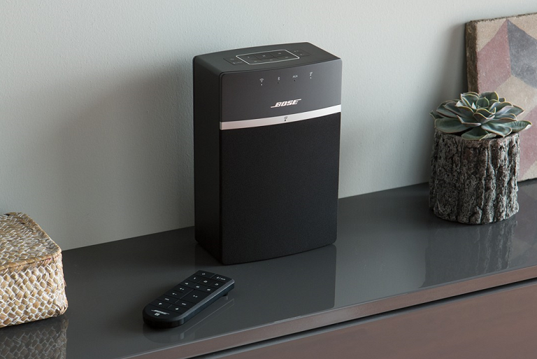 The Bose music system with remote on a sideboard