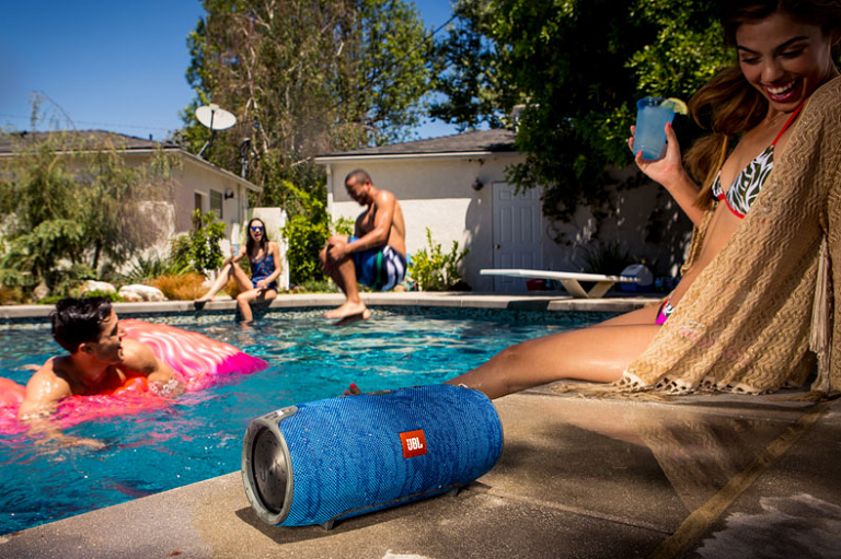 People playing bya pool with the Xtreme portable speaker