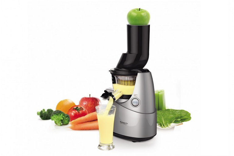 The Kuvings Slow Juicer surrounded by fruits and vegetables