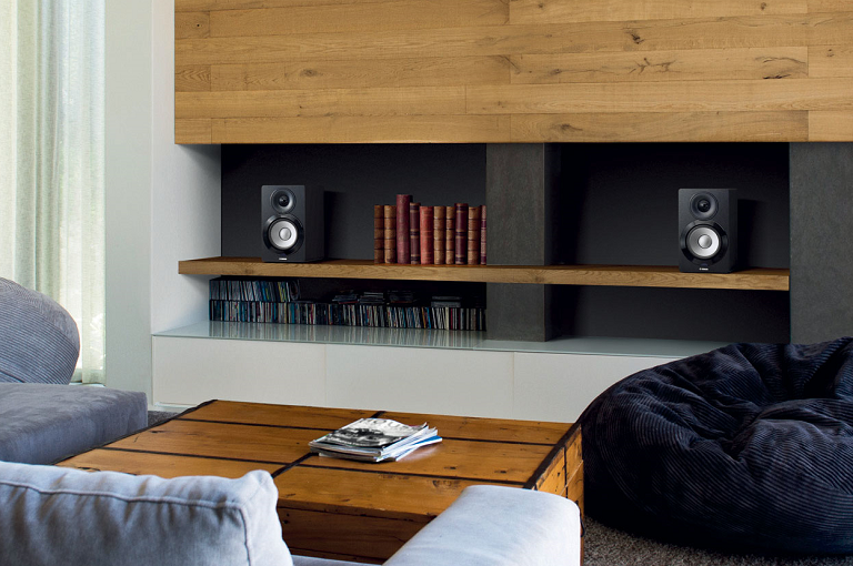 The Yamaha wireless speaker on a bookshelf in a living room